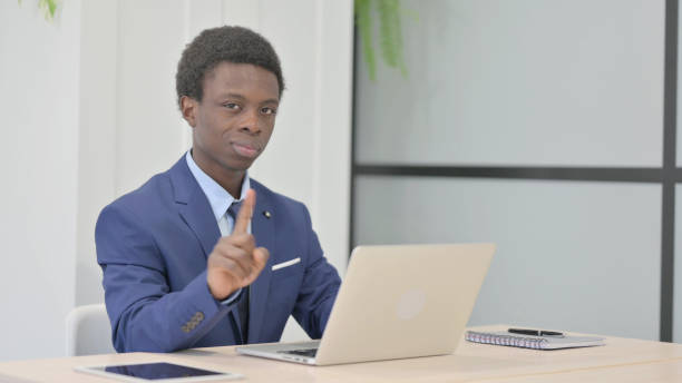 istock African Businessman Shaking Head in Rejection while Working on Laptop 1470502025