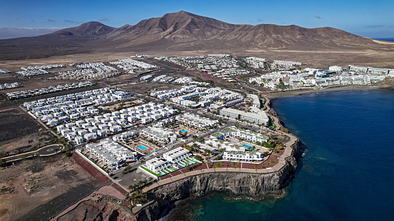 View of beautiful Papagayo beach from above, blue sea, yellow sand, cliffs. Playa Blanca, Lanzarote, Canary Islands. VIew of Fuerteventura on the background, selective focus