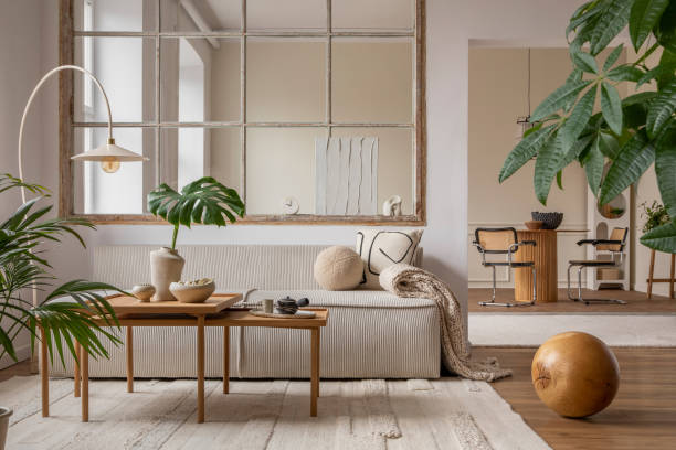 istock Open space interior with modular sofa, wooden coffee table, big window, beige rug, braided plaid, pillows, round table, lamp, plants, slippers, ball and personal accessories. Home decor. Template. 1470504929
