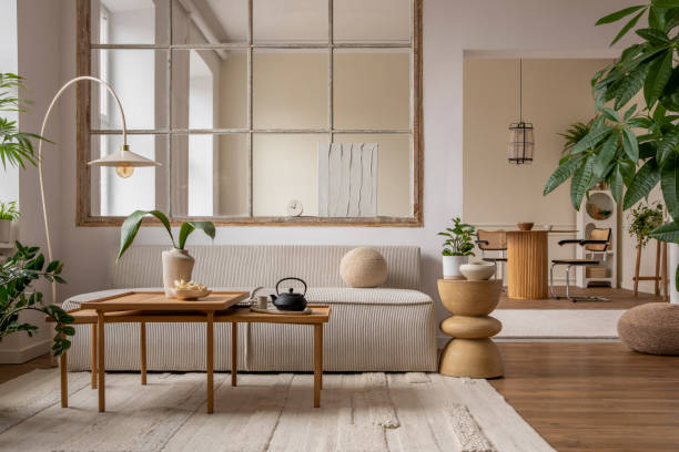 istock Open space interior with modular sofa, wooden coffee table, big window, beige rug, round pillow, stylish table, lamp, plants, vase with leaves and personal accessories. Home decor. Template. 1470504949