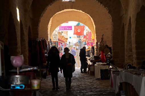 Mahdia, Tunesia, January 29, 2023: View through the passage of the city wall of the old town to the beginning of the souk in the medina