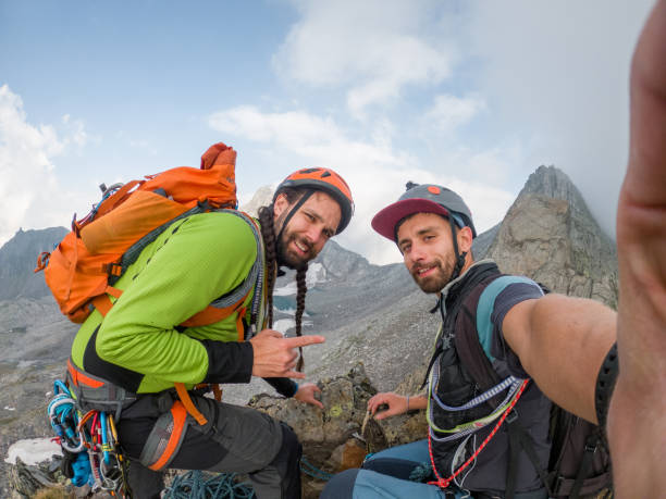 istock Two friends take a selfie while climbing up a mountain 1470505662