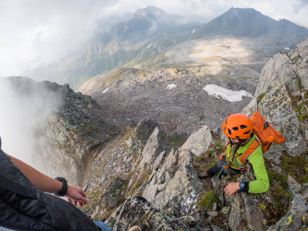 pov of two mountaineers reaching peak - conquering adversity wilderness area aspirations achievement imagens e fotografias de stock