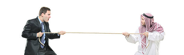 istock Arab person and businessman pulling a rope 147050640