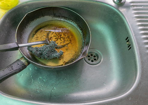 Wash the pan and pour the old oil into the sink. causing clogged sinks and drains