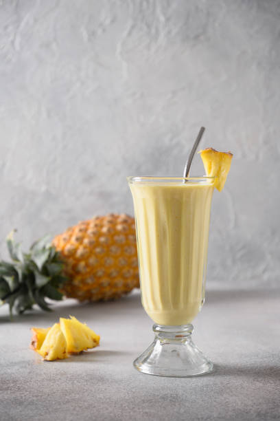 istock Pineapple lassi in glass on gray background. 1470507428