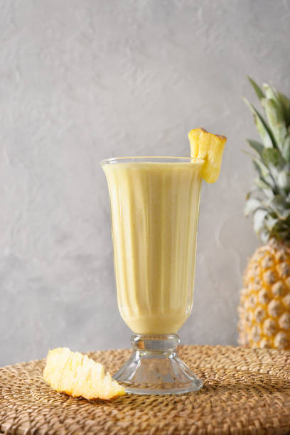 istock Pineapple lassi in glass on gray background. 1470507430