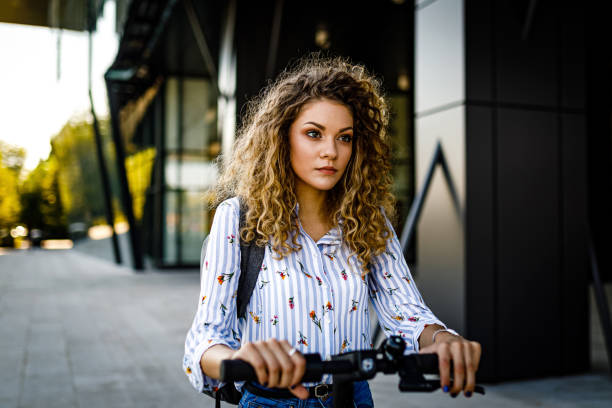 istock Young woman rides push scooter 1470507628