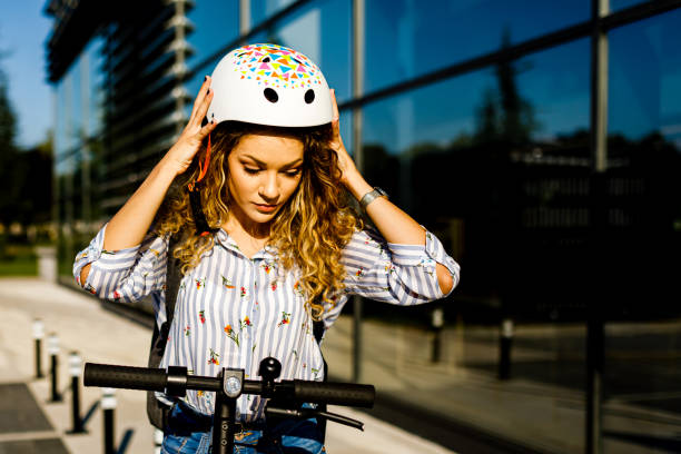istock Young woman puts crash helmet 1470507629