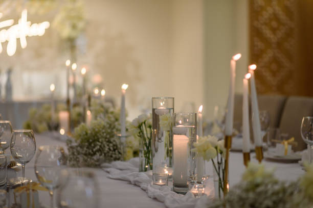 istock Table setting, serving closeup. Wedding setup detail. Banquet decoration in hall restaurant. Luxury reception. Festive table covered tablecloth, decorated composition flowers and candles in party area 1470507727