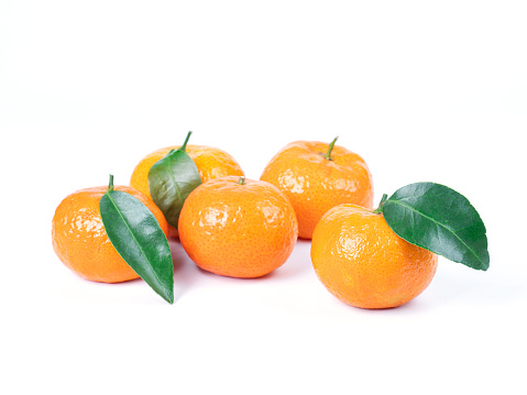 fresh ripe tangerines with green leaf isolated on white background