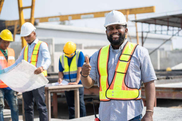 istock Portrait African American engineer man thump up with team working with paper work and precast cement factory background 1470508185