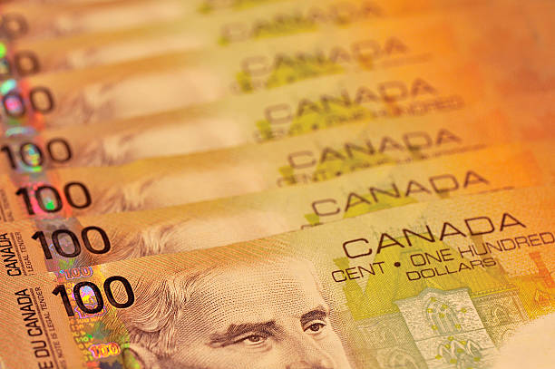 Canadian 100 Dollar Bills 7 100 dollar bills with receding focus. canadian currency photos stock pictures, royalty-free photos & images