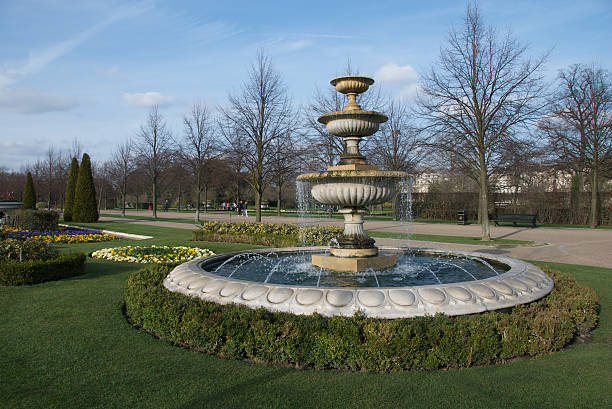 A closeup of a fountain in the Regent's park with a sunset sky background
