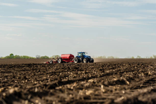 istock A tractor cultivating field at spring morning. 1470513792