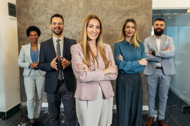 istock Successful group of business people at modern office looking at camera. 1470514473