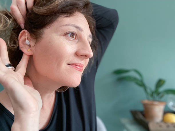 istock Smiling woman showing her properly placed hearing aid 1470514671
