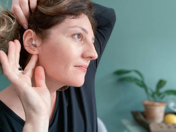 istock Smiling woman showing her properly placed hearing aid 1470514685