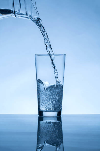 istock water from jug pouring into glass 1470516358