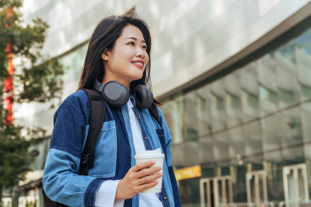 istock Young Asian woman student with coffee and backpack 1470516907