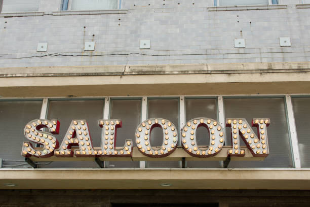 istock Vintage SALOON sign made with cut out letters and light bulbs 1470517761