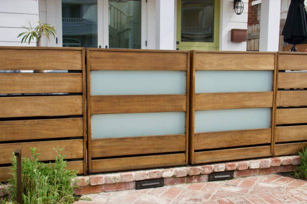 Modern garden gate made with frosted glass and horizontal teakwood