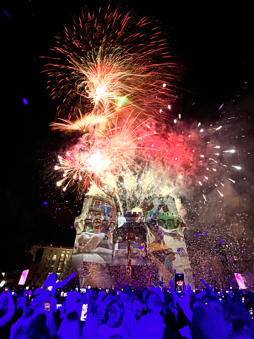 Valencia, Comunidad Valenciana, Spain - February 26: People enjoying fireworks on Fallas' opening ceremony in front of the Torres de Serrano.\n\nLas Fallas or \