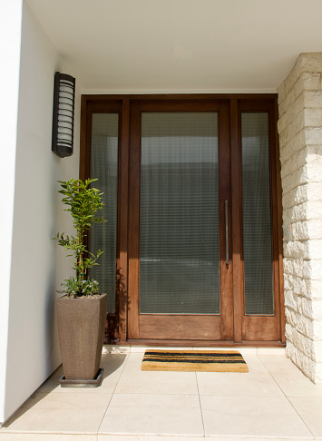 Modern three piece front door made with textured glass and hardwood