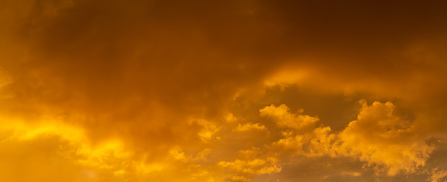 Sky background at sunset,Sky blue and orange light of the sun through the clouds in the sky