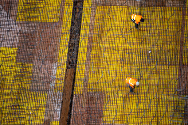 istock Top view of workers preparing a concrete foundation plate at a construction site. 1470520769