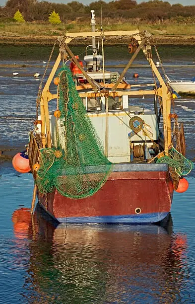 A moored up fishing boat in Keyhaven estuary in Hampshire England
