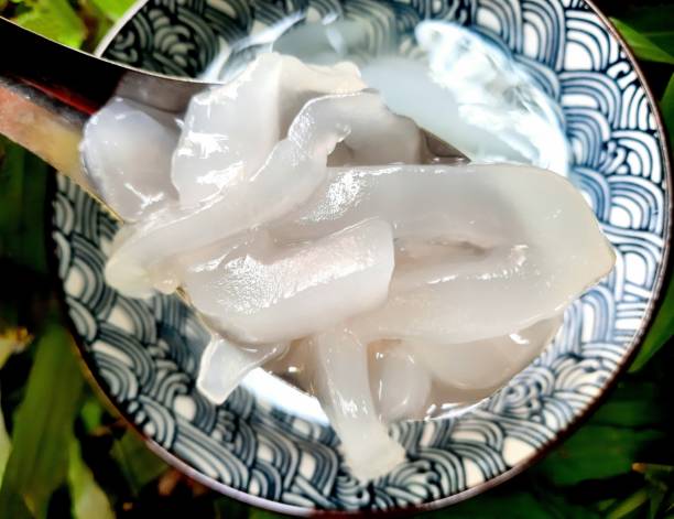 istock Eating Toddy Palm fruit in syrup - sweet dessert. 1470520965