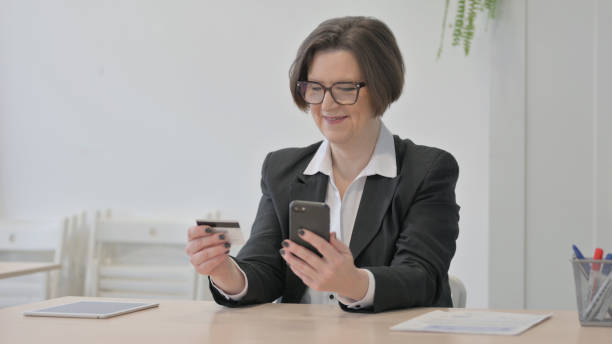 istock Old Businesswoman making Successful Online Payment 1470522467