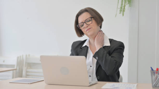 istock Old Businesswoman having Neck Pain while using Laptop 1470522746