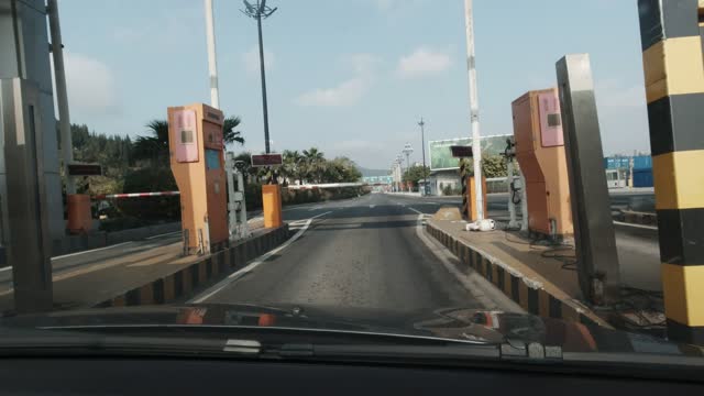 Driving through a road toll booth