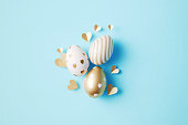 Gold Painted Easter Eggs  On Blue Background