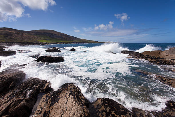 Waves crashing on rocks in a bay stock photo