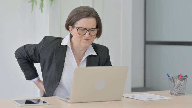 istock Old Businesswoman having Back Pain while using Laptop 1470526601
