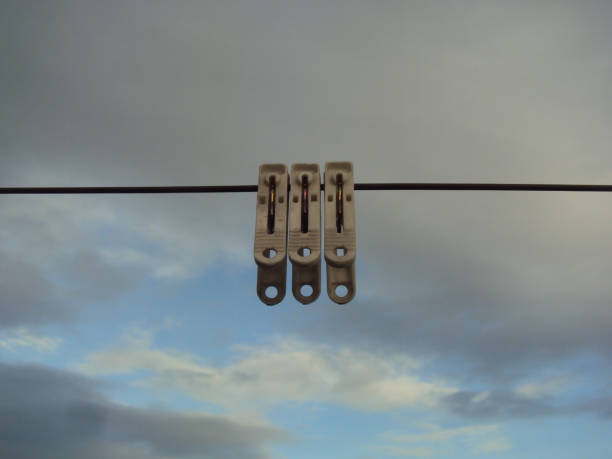 Clothespins on a clothesline with a sky background