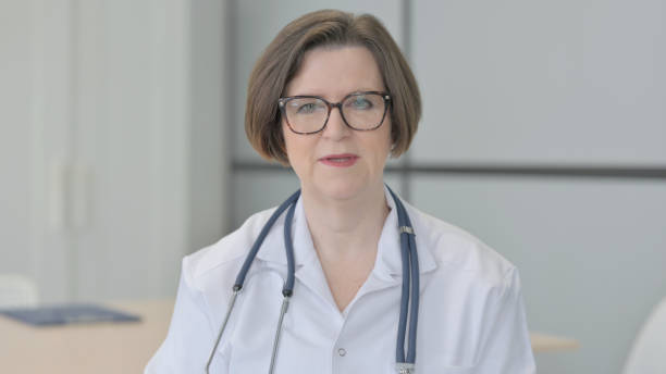 istock Senior Doctor Talking on Online Video Call 1470530766
