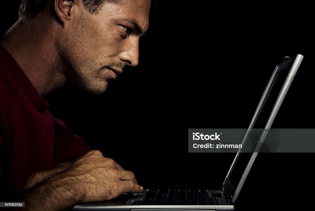 Man concentrating Man concentrating on computer Adult Stock Photo