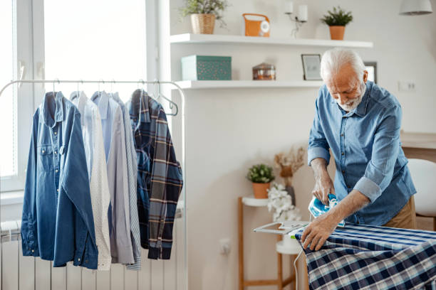 istock Elderly Man Ironing Shirt at Home 1470531853