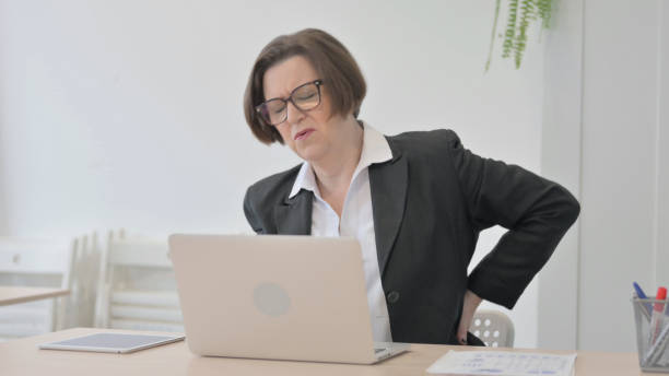istock Old Businesswoman having Back Pain while using Laptop 1470532428