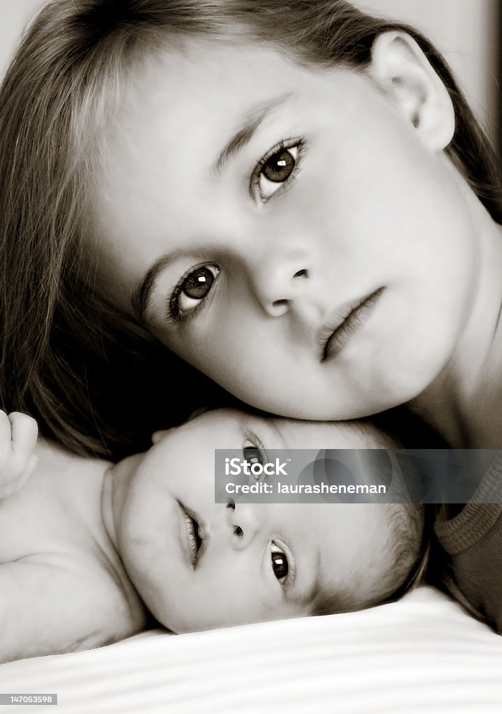 Big Sister New big sister with newborn baby sister.  Strong family resemlance.  Beautiful eyes. Newborn Stock Photo