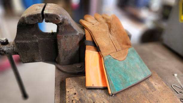 istock Blue Collar workers.  Safety gloves on workbench. 1470537724