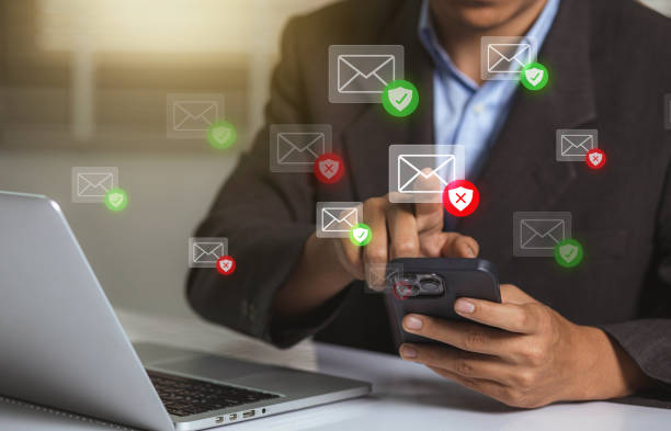 istock Businessman using smartphone with electronic email hacking and spam warning symbol. cyber attack network, virus, spyware, Cyber security and cybercrime 1470537797