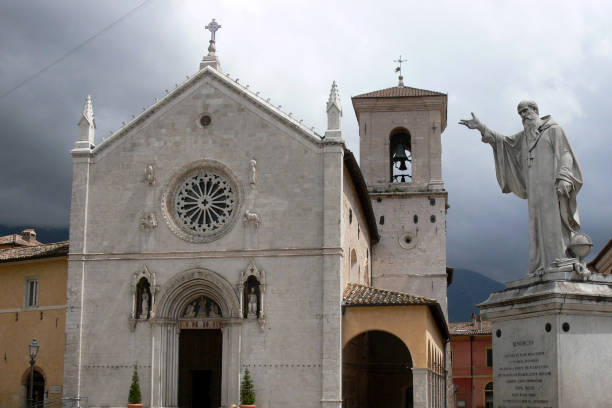 Medieval cathedral in Norcia, Umbria, Italy with the statue of St Benedict stock photo