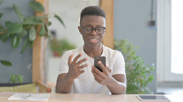 istock African Man Sad about Loss on Smartphone 1470539888