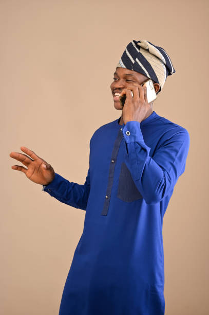 istock African man talking on a mobile phone call with his right hands stretched out in demonstration 1470540020