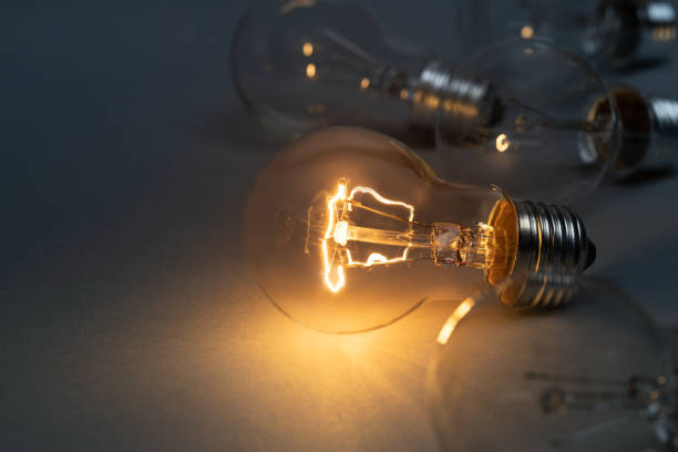 istock Idea concept with classic light bulb glowing in the dark 1470540280